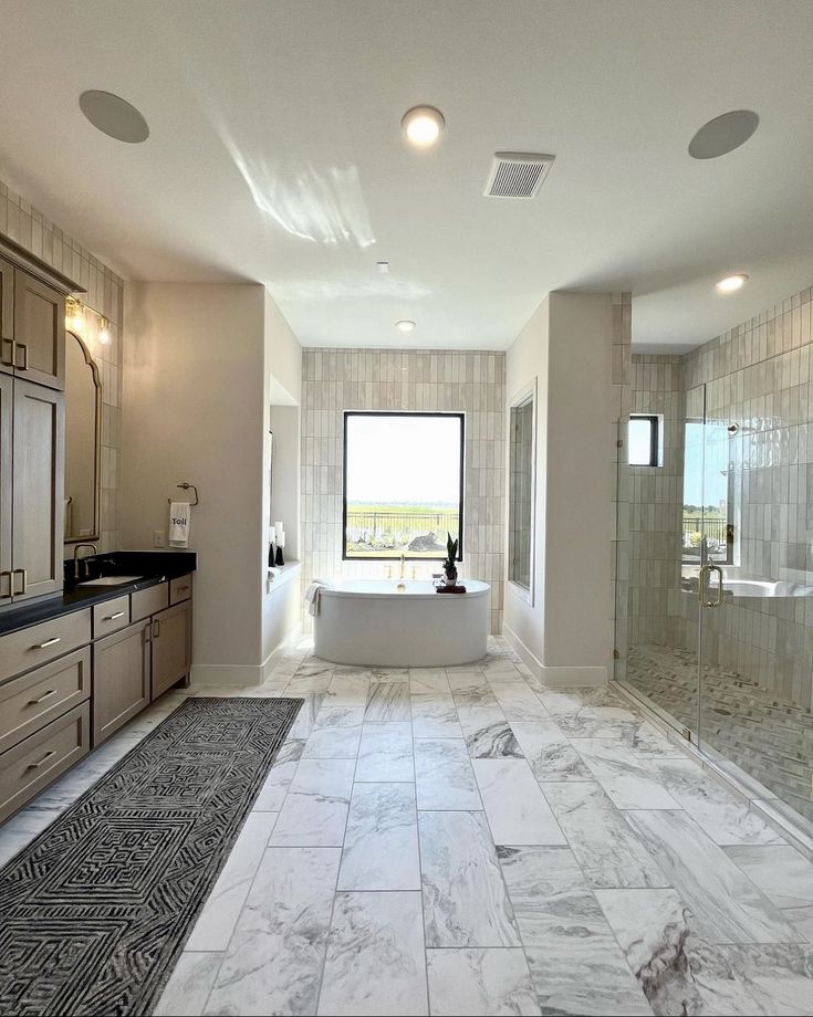 Modern renovated bathroom with wood vanity and glass shower in an Etobicoke condo